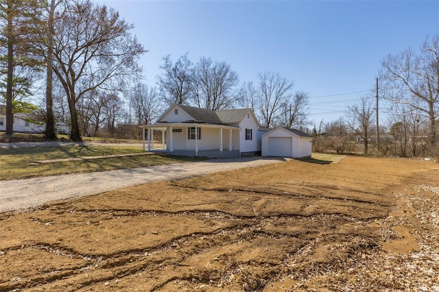 view of front of property with a porch, driveway, a front yard, and a garage