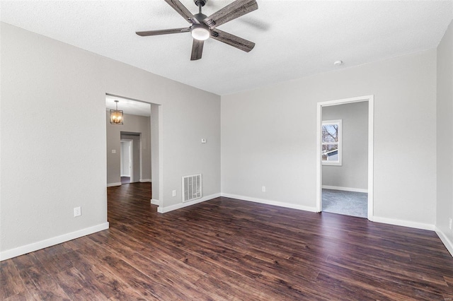 spare room featuring visible vents, baseboards, a textured ceiling, a ceiling fan, and dark wood-style flooring