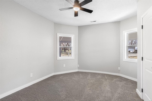 empty room featuring baseboards, carpet, a ceiling fan, and a textured ceiling