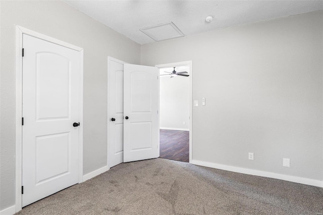 unfurnished bedroom with baseboards and carpet