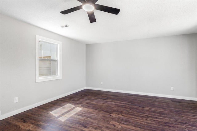 unfurnished room featuring visible vents, baseboards, ceiling fan, and wood finished floors