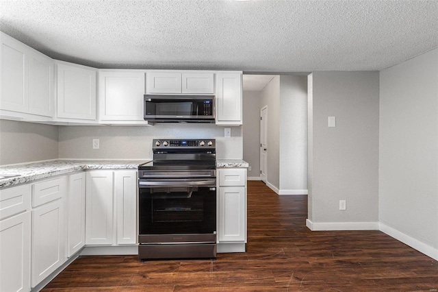 kitchen with stainless steel appliances, white cabinets, and dark wood-style flooring