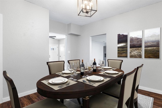 dining area with wood finished floors, baseboards, and a chandelier