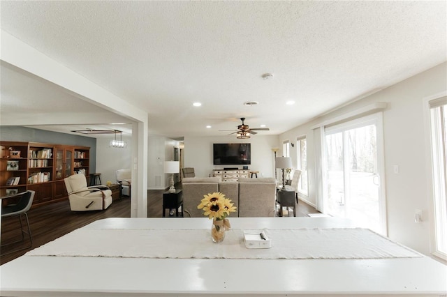 dining room with ceiling fan, a textured ceiling, dark wood-style floors, and recessed lighting