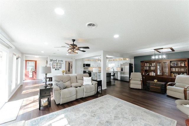 living area with dark wood-style floors, visible vents, recessed lighting, and ceiling fan