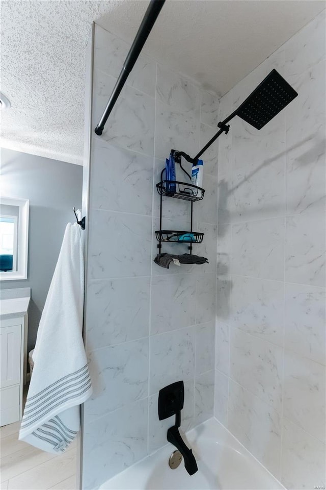 bathroom featuring a textured ceiling and shower / bath combination