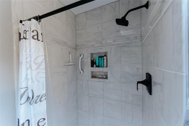 full bath with a tile shower