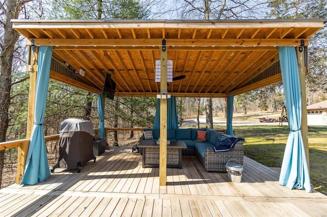 wooden terrace featuring a grill and an outdoor hangout area