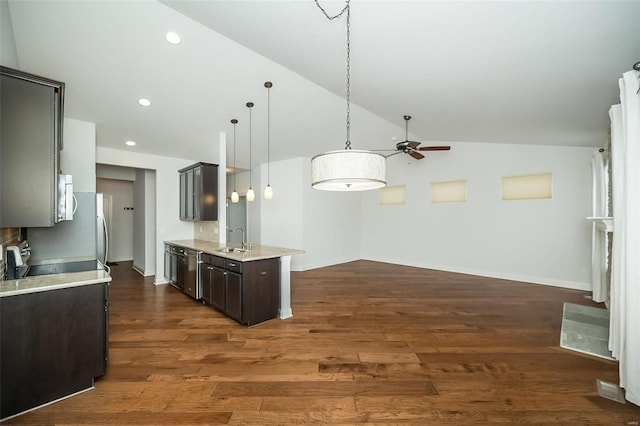 kitchen with dark brown cabinetry, dark wood-style floors, lofted ceiling, and a sink