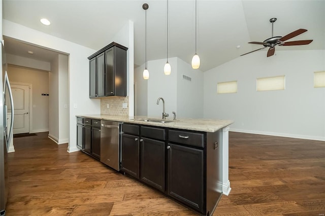 kitchen with backsplash, dark wood-type flooring, dishwasher, a peninsula, and a sink