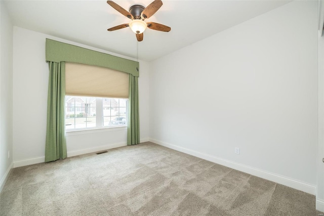 unfurnished room with a ceiling fan, baseboards, and carpet floors