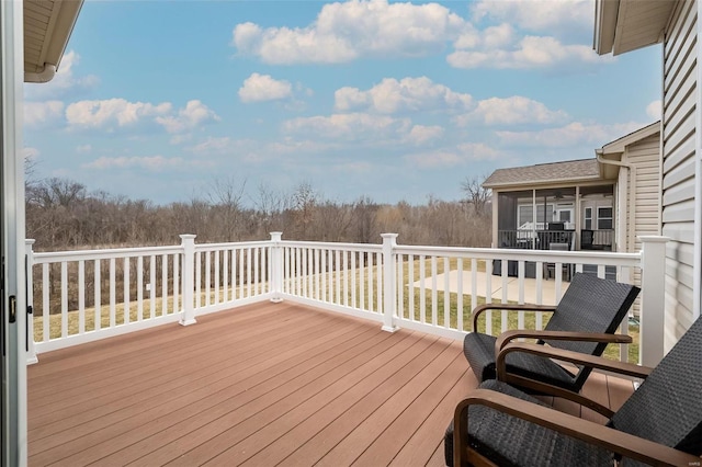 wooden deck with a sunroom