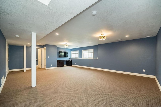 basement featuring carpet flooring, recessed lighting, a textured ceiling, and baseboards