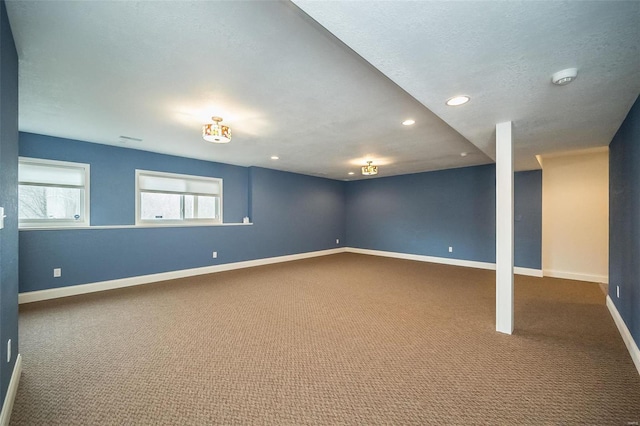 carpeted empty room featuring recessed lighting, a textured ceiling, and baseboards