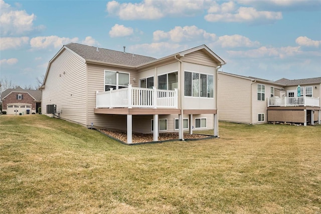 rear view of property with cooling unit, a lawn, and a sunroom