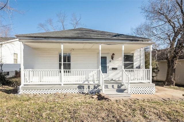 view of front facade featuring covered porch and roof with shingles