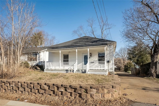 view of front of home featuring roof with shingles and covered porch