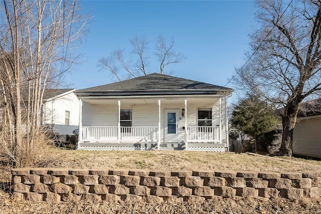 view of front of home with roof with shingles and a porch