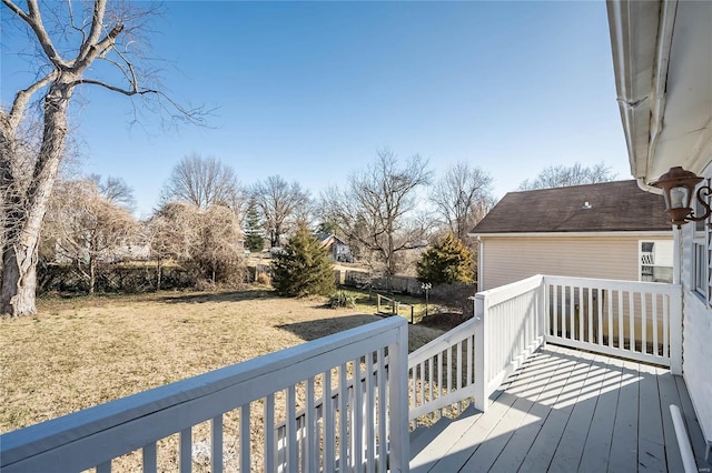 wooden terrace featuring a yard