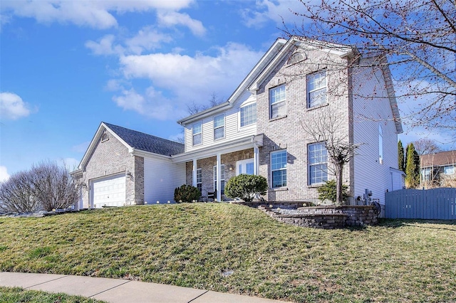 view of front facade featuring brick siding, an attached garage, a front yard, and fence