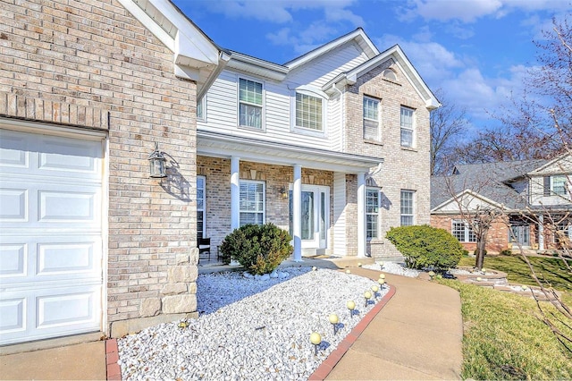 view of front of house with brick siding and a garage