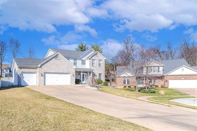 view of front facade with a front yard, an attached garage, brick siding, and driveway