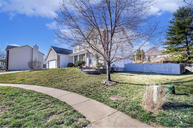 view of yard with an attached garage and fence