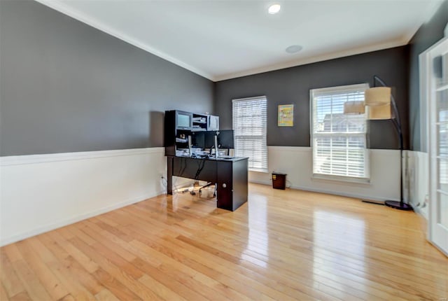 office area featuring baseboards, wood finished floors, wainscoting, and ornamental molding