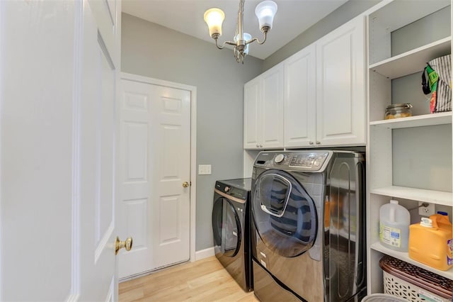 laundry area featuring cabinet space, a chandelier, washer and dryer, and light wood-style flooring