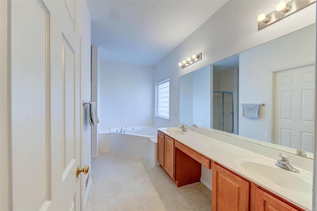 full bathroom featuring a bath, a shower stall, double vanity, and a sink