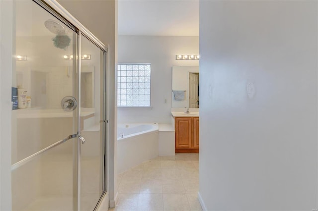 full bath featuring vanity, a shower stall, a garden tub, and tile patterned flooring