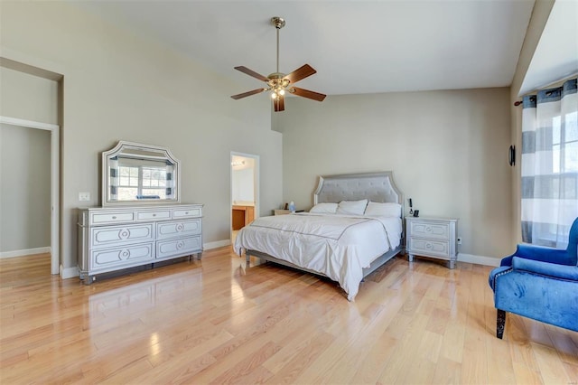 bedroom with light wood finished floors, a ceiling fan, lofted ceiling, and baseboards