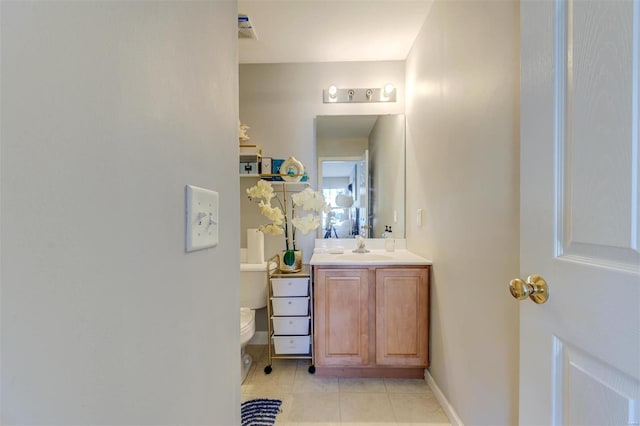 bathroom featuring tile patterned flooring, toilet, vanity, and baseboards