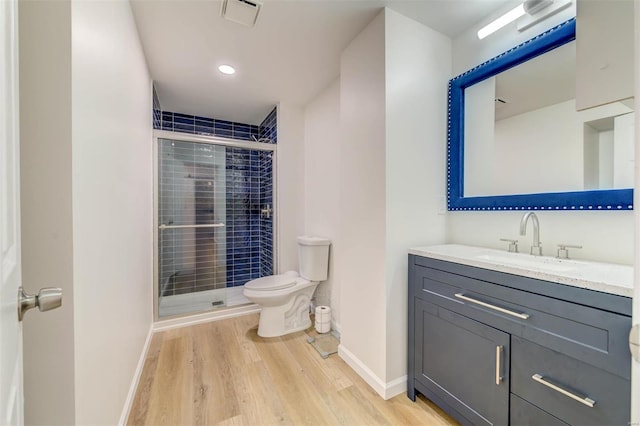 full bath with a stall shower, visible vents, toilet, and wood finished floors