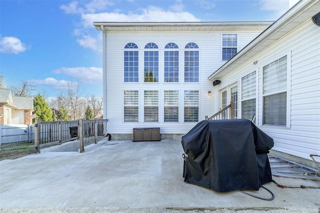 view of patio with a grill and fence