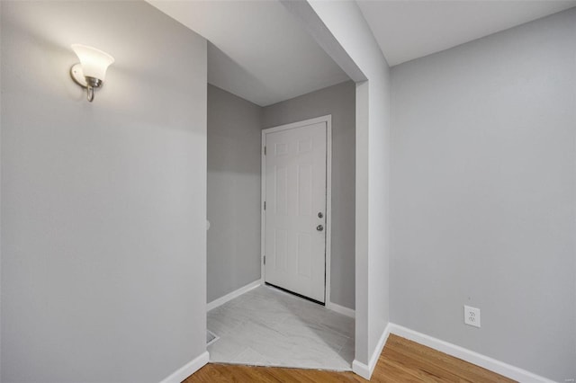 interior space with baseboards and wood finished floors