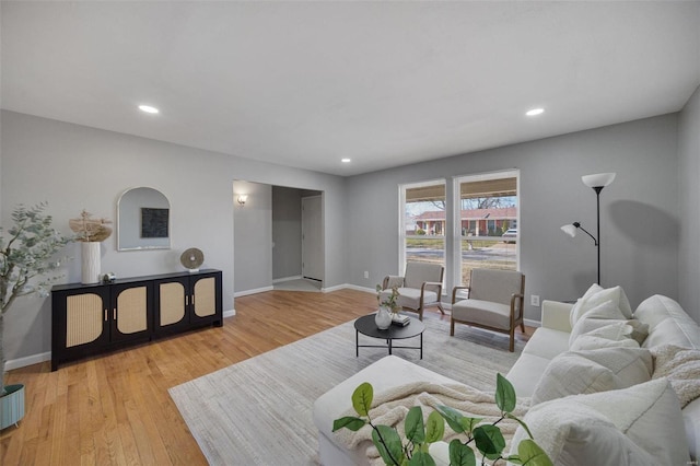 living area with recessed lighting, baseboards, and light wood-style floors