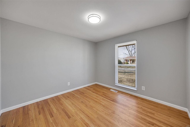 unfurnished room with visible vents, baseboards, and light wood-style floors