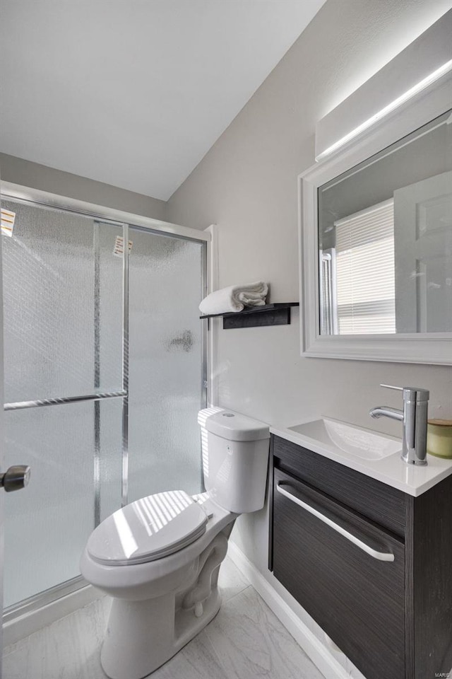 bathroom with marble finish floor, vanity, toilet, and a shower stall