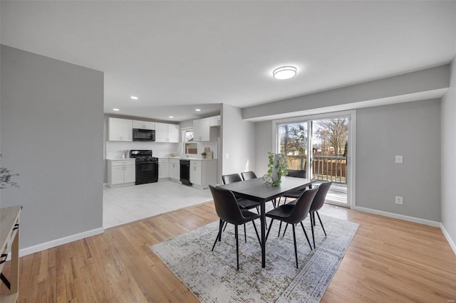 dining room with recessed lighting, baseboards, and light wood-style flooring