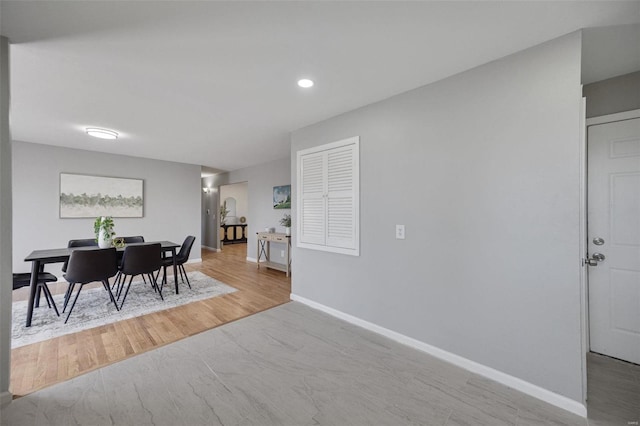 dining space with wood finished floors and baseboards