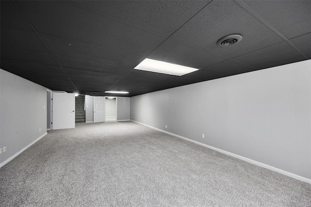 finished basement featuring a drop ceiling, baseboards, visible vents, and carpet floors