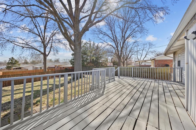 wooden deck with a yard, a residential view, and a fenced backyard