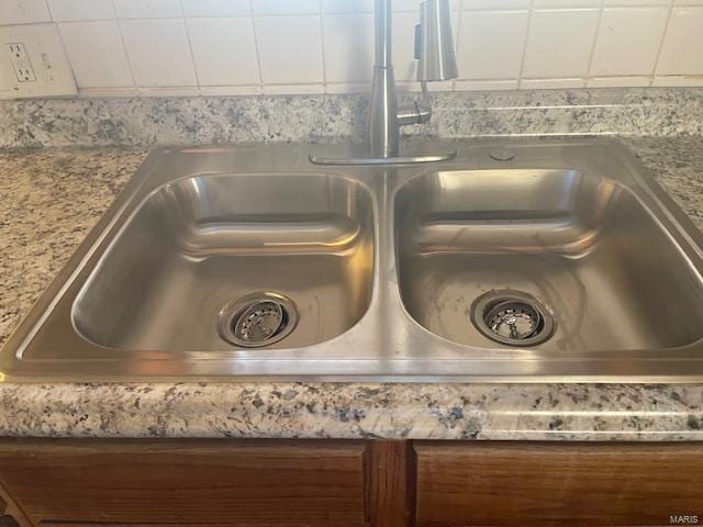 room details with a sink, white cabinetry, and light countertops