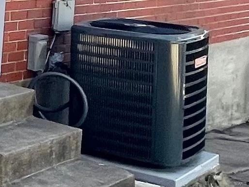 exterior details featuring central air condition unit and brick siding