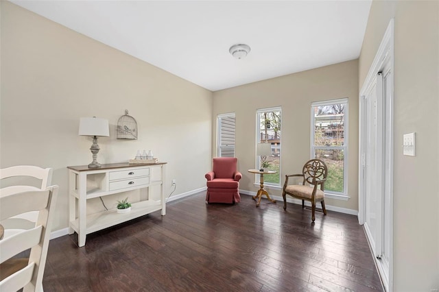 living area featuring hardwood / wood-style floors and baseboards