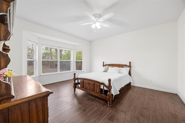 bedroom featuring baseboards, ceiling fan, and wood finished floors