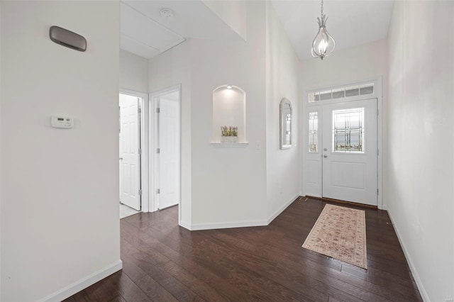 entryway featuring dark wood-style floors and baseboards
