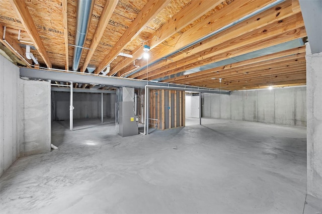 unfinished below grade area featuring heating unit
