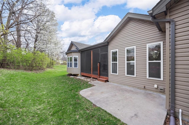view of yard with a sunroom and a patio